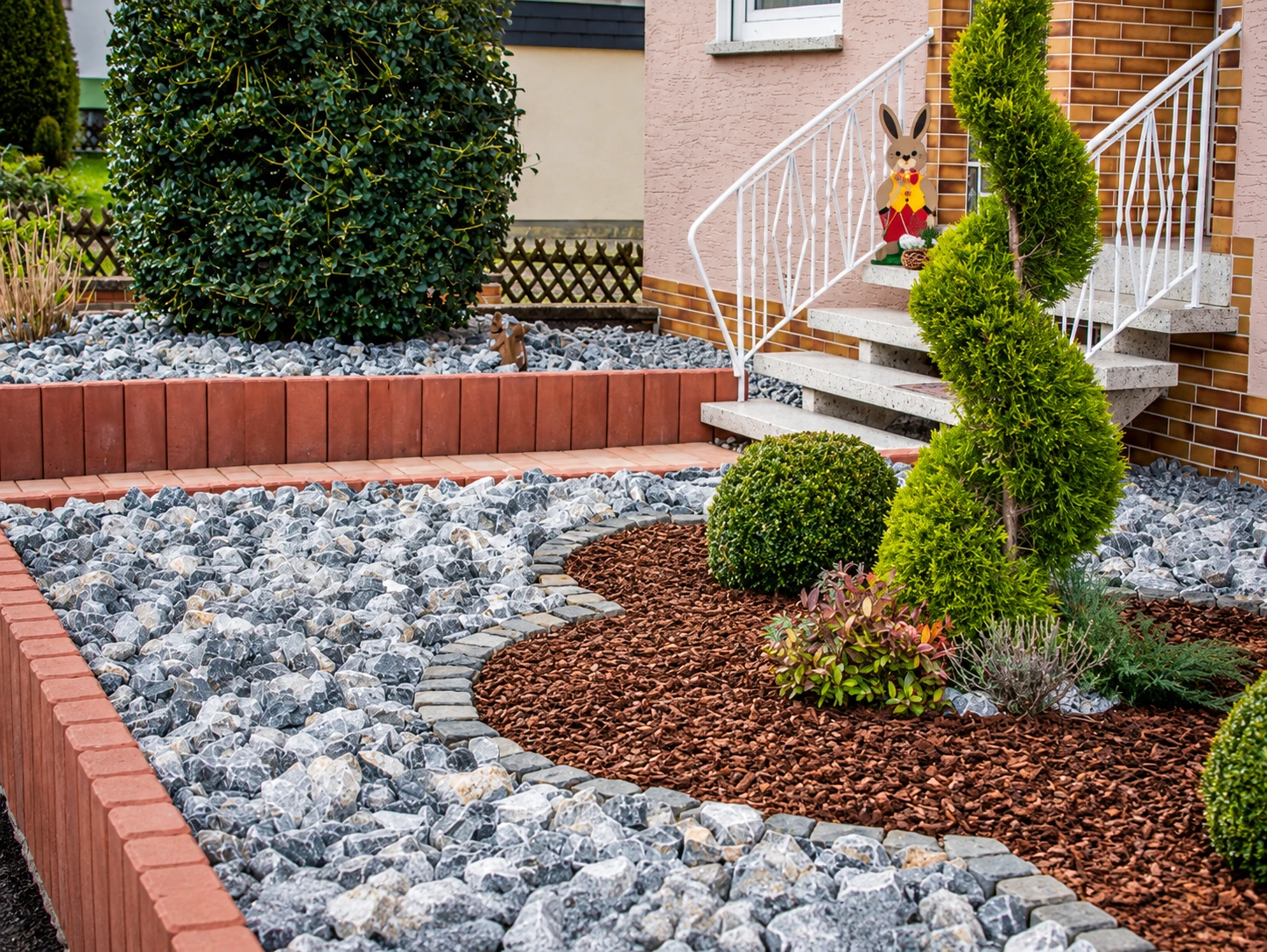 Gartengestaltung mit Natursteinflächen und Bepflanzung
